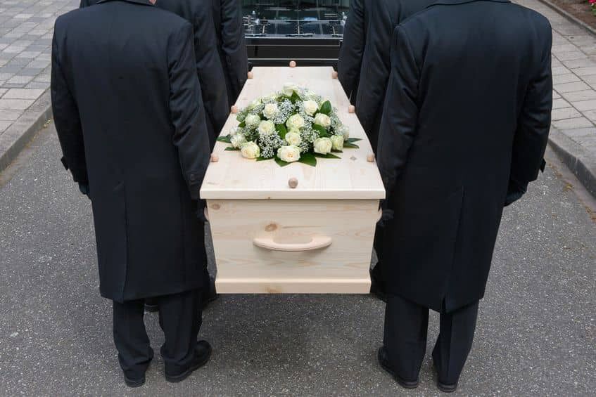 20246204 - bearers a carrying a coffin into a car